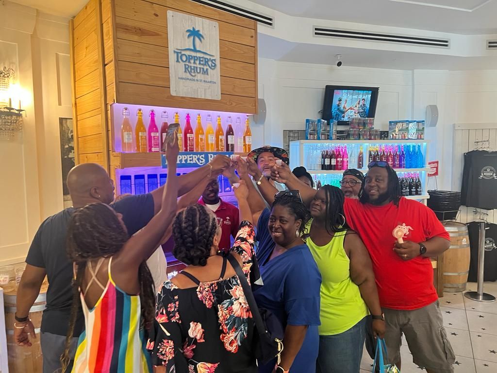 Guests toasting together at Topper's Rhum in St. Maarten during a Sunita Tours island tour